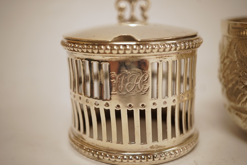 A George III silver helmet shaped cream jug, marks rubbed, 10cm(a.f.), together with a later Victorian silver sugar bowl and similar pierced silver mustard pot, no liner.